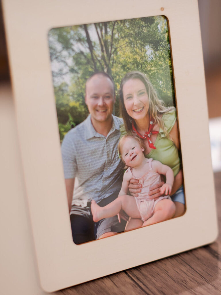 Photo frame featuring parent caregivers and their special needs daughter.