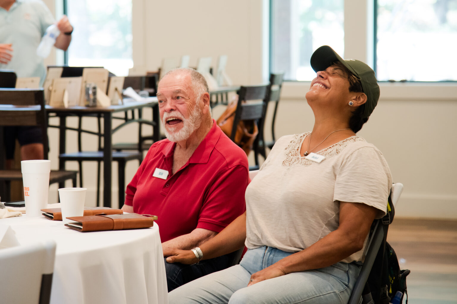 Caregiver celebrating strength and resilience during wellness retreat activity.