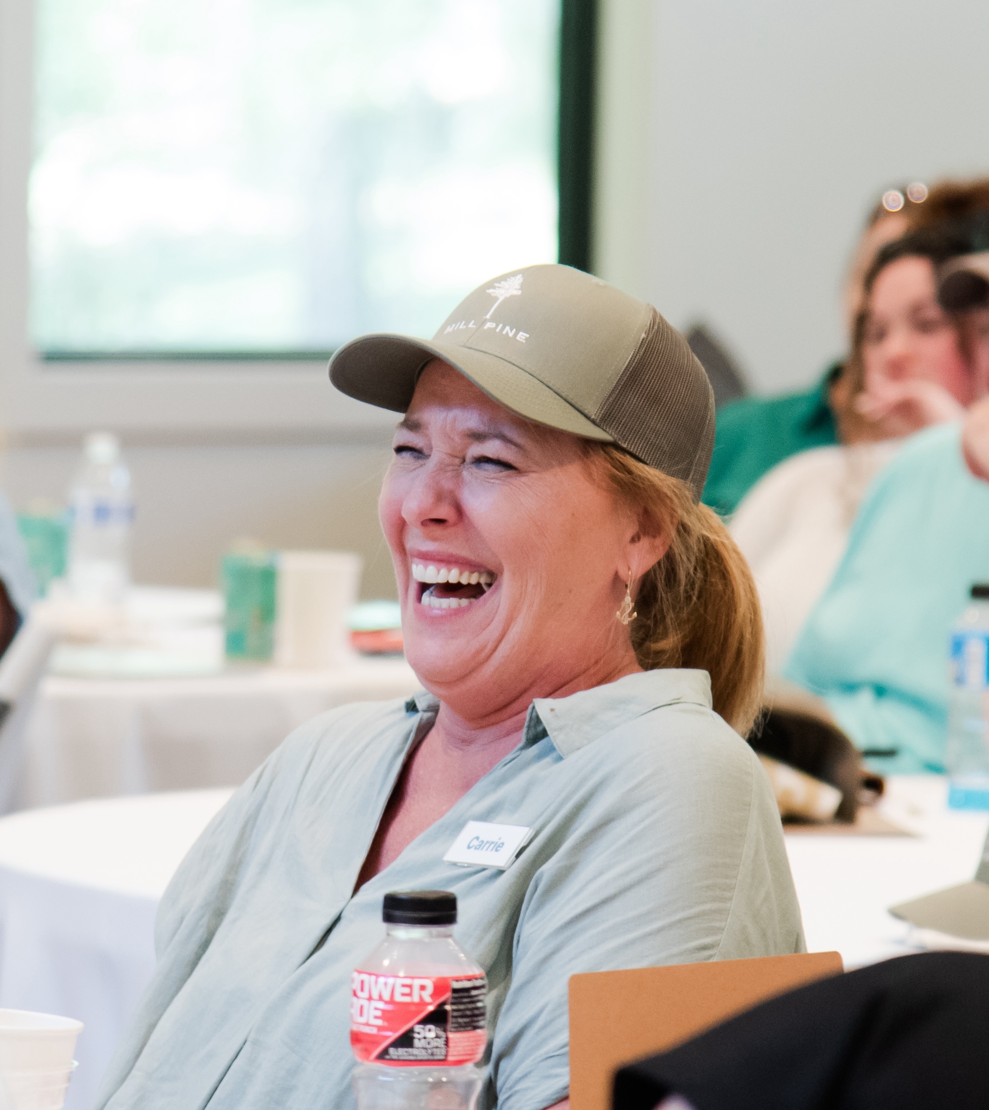 Caregiver smiling during a group workshop on Mental Health.