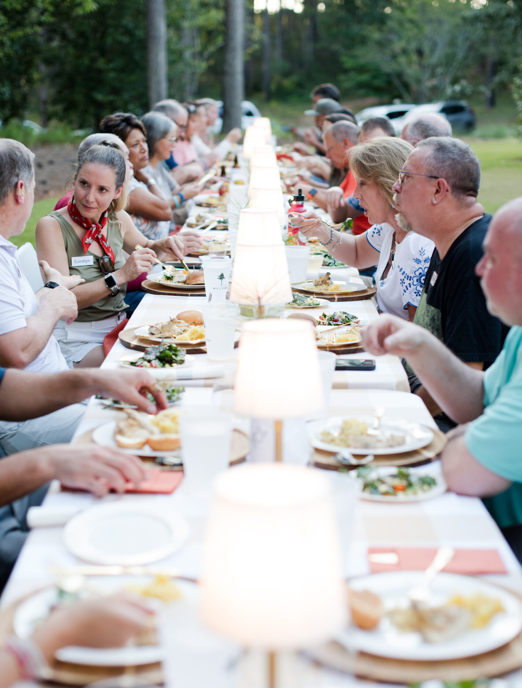 Group of caregivers celebrating community connection during retreat dinner.