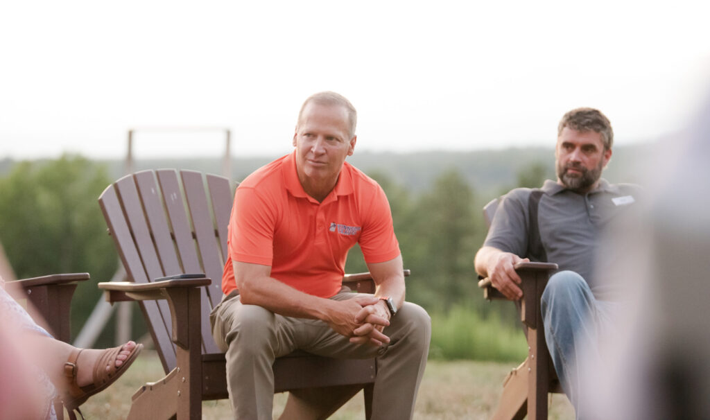 Caregivers talking outdoors, building networks of support and resilience.