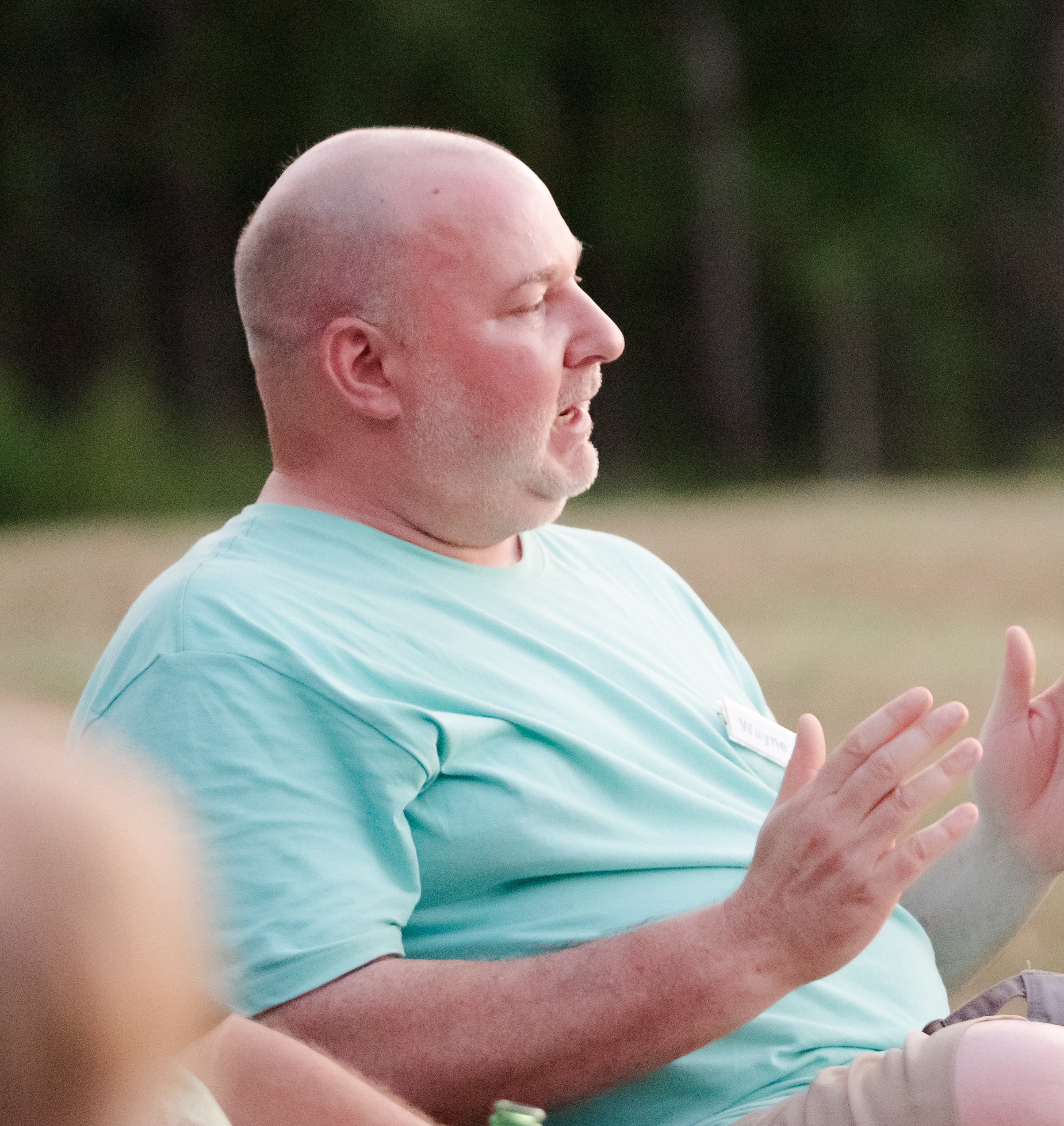 Group of caregivers in discussion during an outdoor session at a retreat