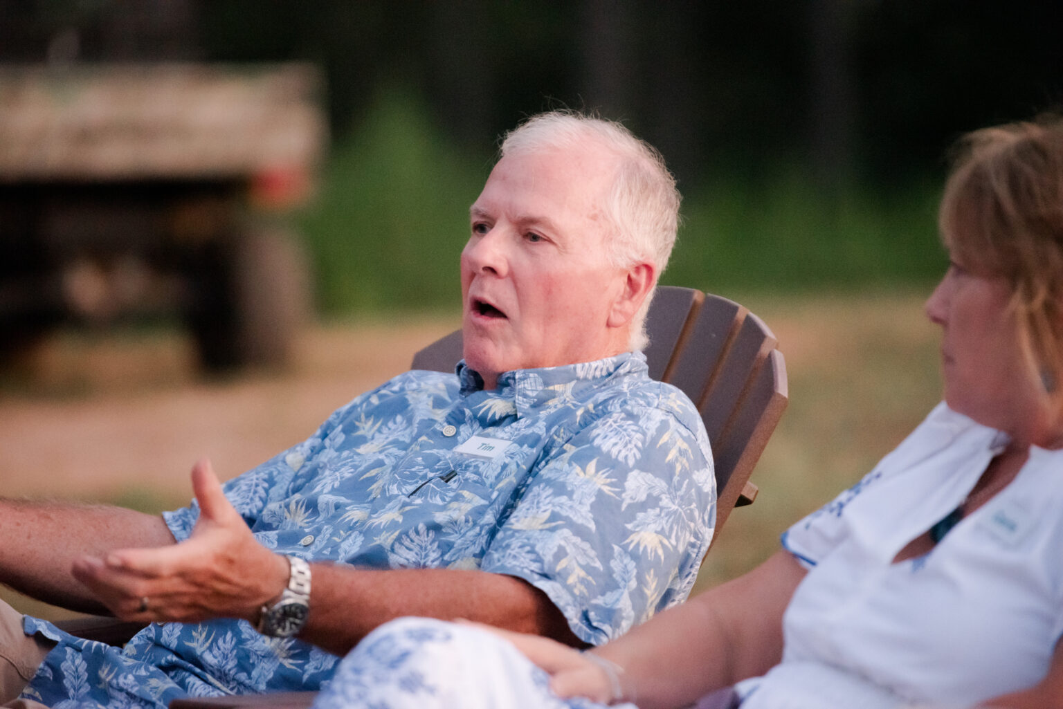 Caregiver leading discussion during group therapy session at retreat.