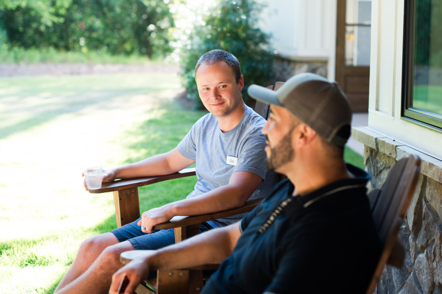 Caregivers relaxing outdoors and discussing wellness during retreat activities.